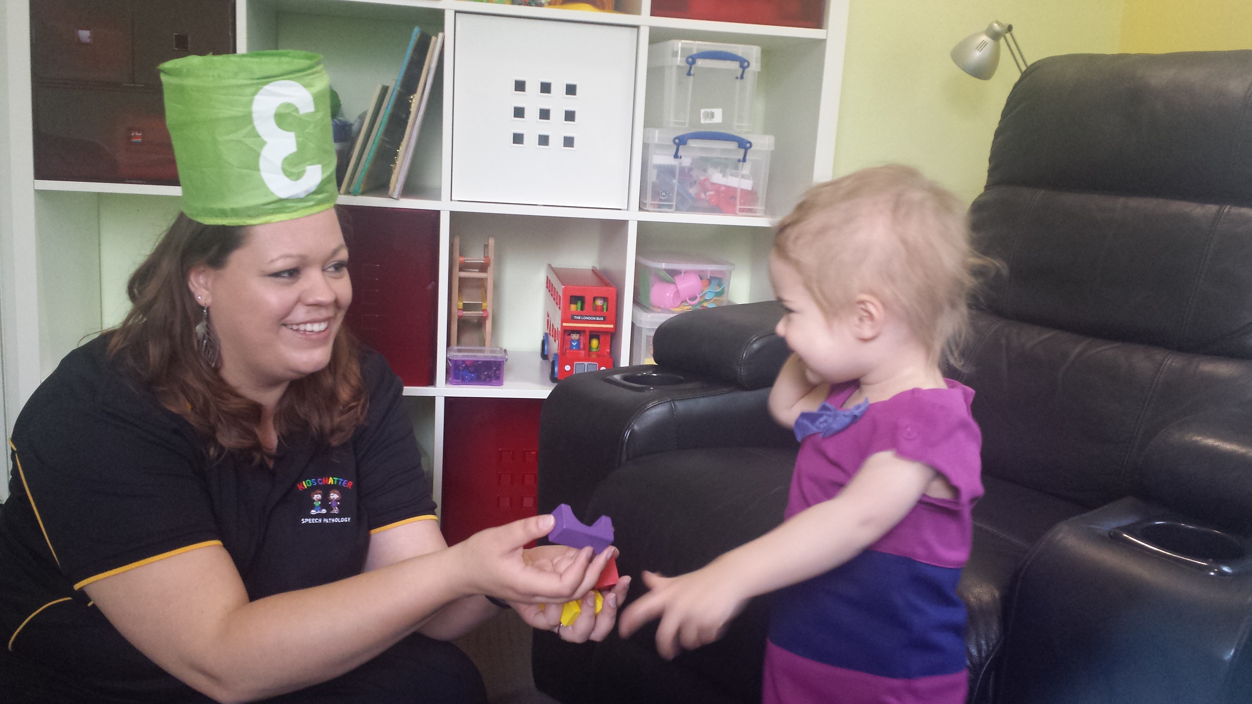 Speech therapist and toddler interacting